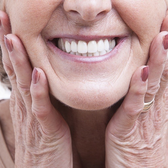 Woman showing off a full denture