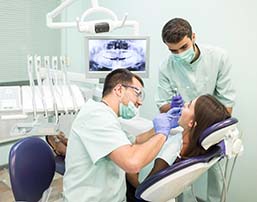 Emergency dentist in Royce City performing exam on a patient