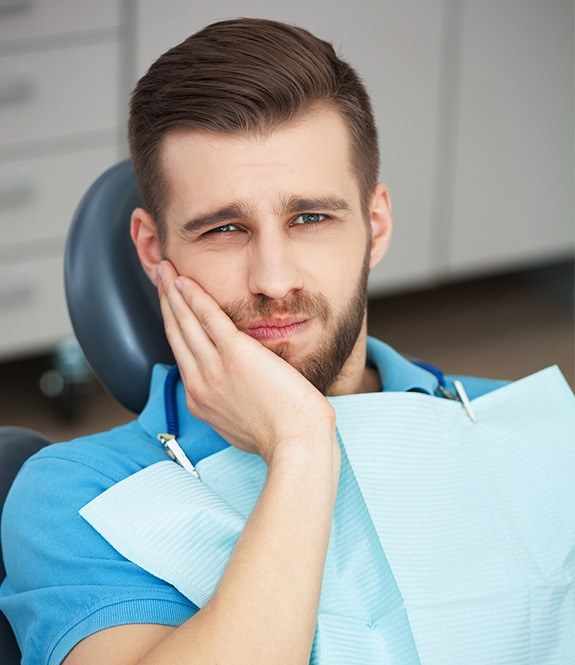 Man with toothache at dental office for tooth extraction