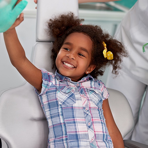 Smiling child at dental office relaxed with oral conscious sedation dentistry