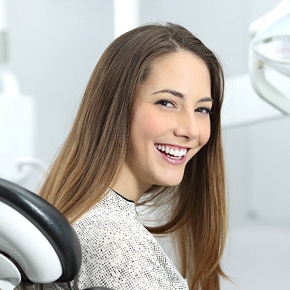 Woman with tooth-colored filling smiling at dentist office