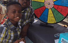 Child playing game at community event in Royse City