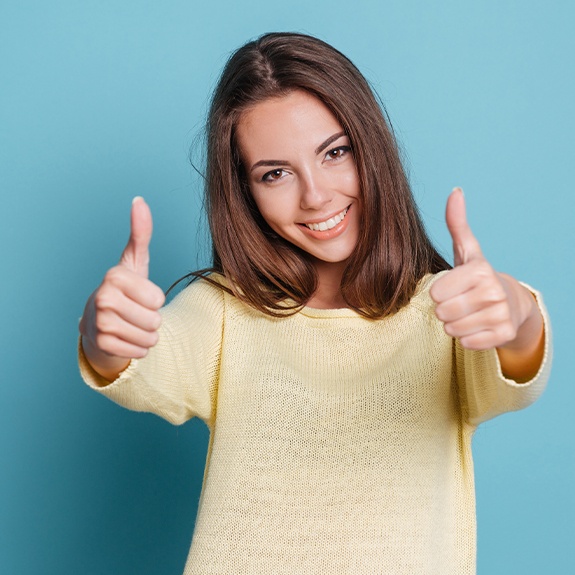 Smiling woman giving thumbs up