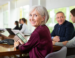 Senior businesswoman smiling while at a meeting