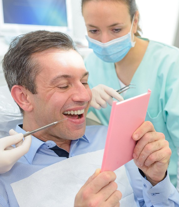 Dentists pointing to a patient’s teeth