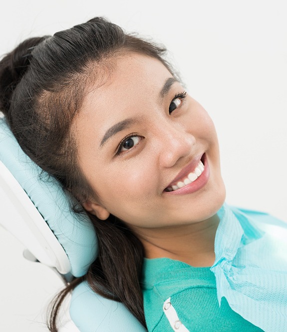 Smiling dental patient in a chair