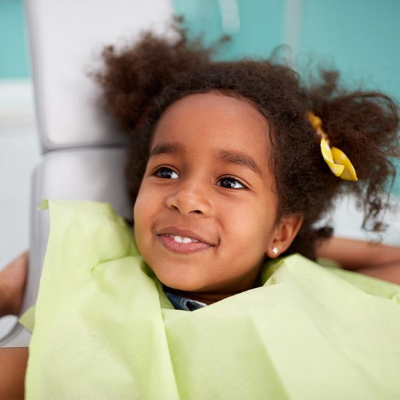 Little girl smiling after fluoride treatment