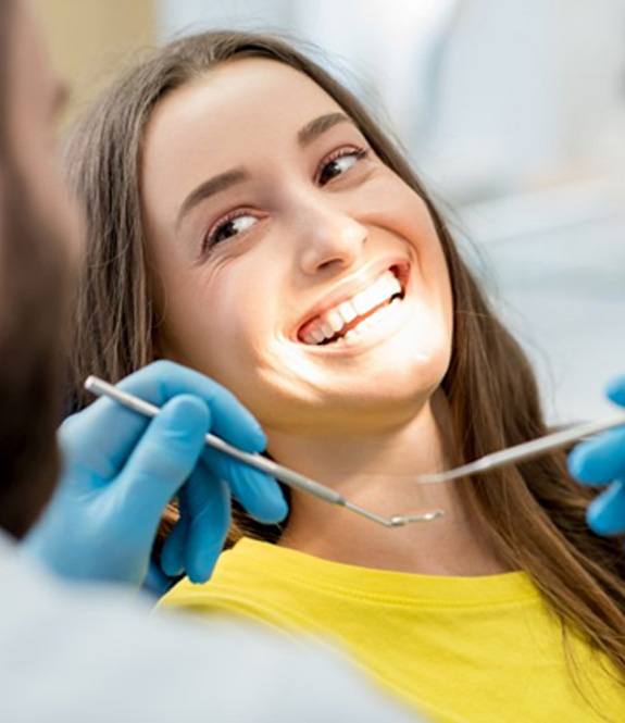 Woman smiling during her Royse City dental checkup and cleaning.