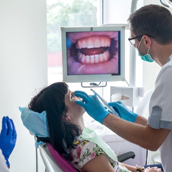 Royse City dentist examining patient’s mouth during checkup