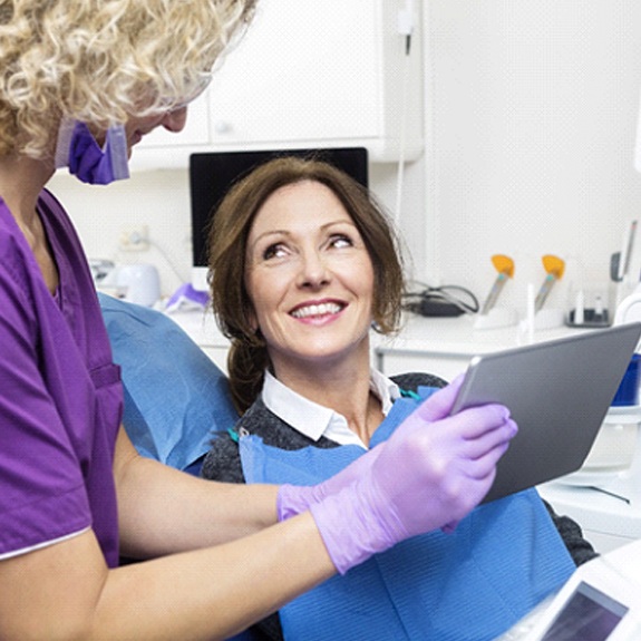 Older woman learning dental implants in Royse City