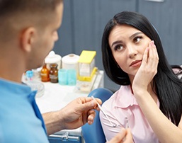 woman with a toothache talking to her emergency dentist in Royse City 