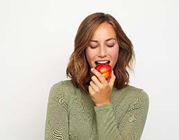 Woman biting into an apple