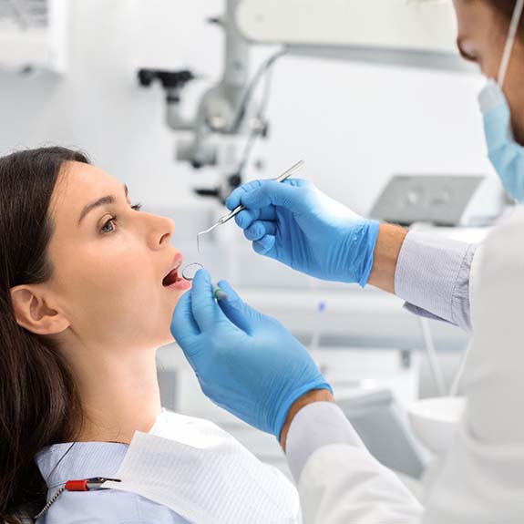 Emergency dentist in Royce City performing a dental exam