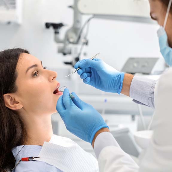 Emergency dentist in Royse City performing a dental exam