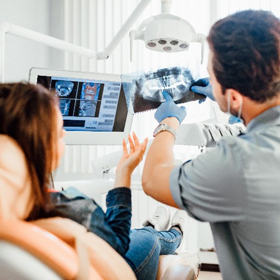 Emergency dentist showing patient their X-ray