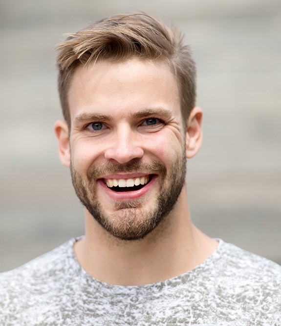 man smiling after fluoride treatment 