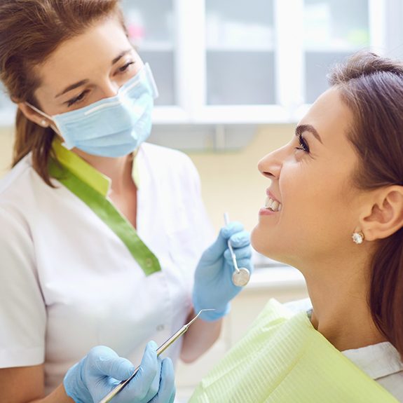 Woman visiting her implant dentist in Royse City for exam