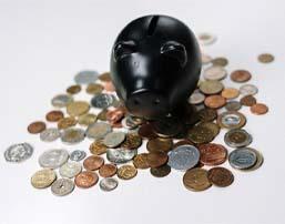 Loose coins and black piggy bank