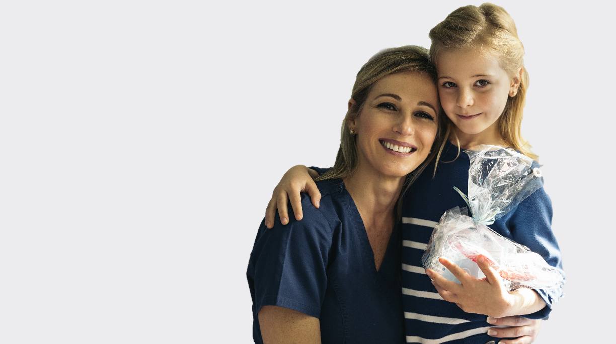 Mother and daughter holding oral hygiene gift basket in Royse City