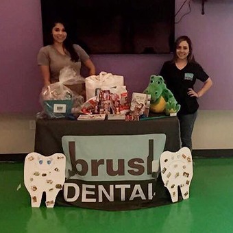 Two dental team members at table for Brush Dental