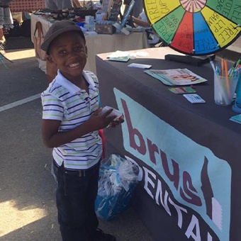 Smiling child at community event in Royse City