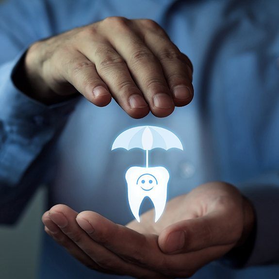 Hand holding animated tooth under an umbrella