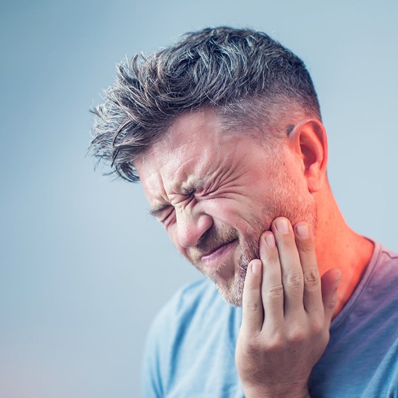 A patient experiencing dental pain in Royse City, TX