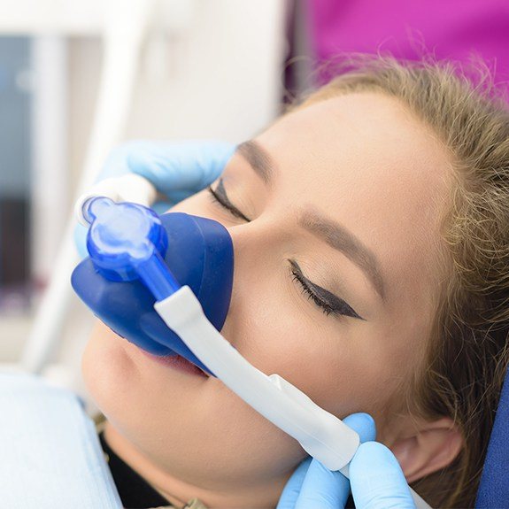 Woman with nitrous oxide dental sedation mask