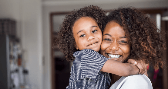 Mother and daughter smiling after replacing missing teeth