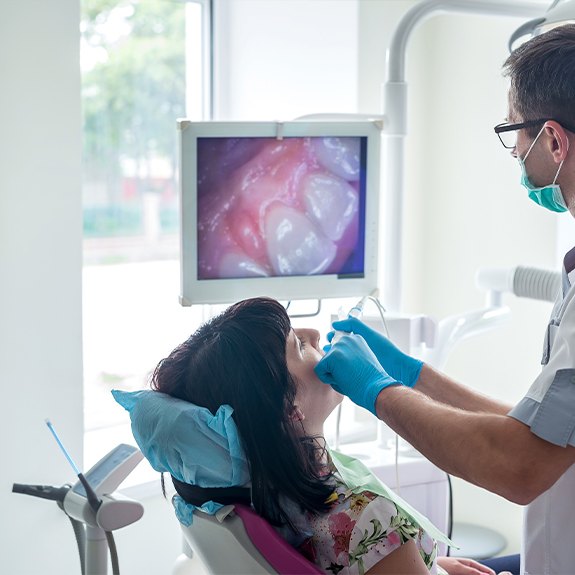 Dentist and dental patient looking at intraoral images