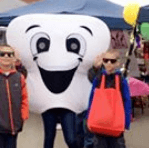 Two kids with tooth mascot