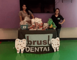 Two dental team members at table for Brush Dental
