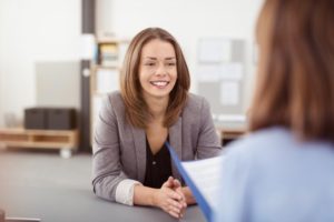 woman in a job interview after getting cosmetic dental treatments 