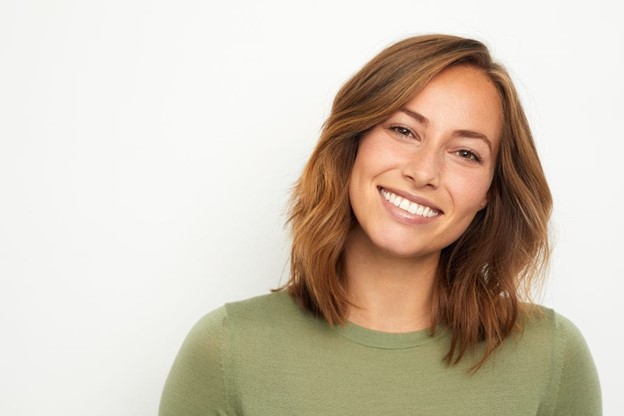 person with a dental bridge smiling