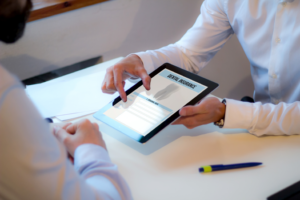 a patient and dentist reviewing a digital insurance form
