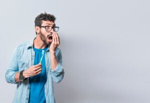 man trying to smell his own breath